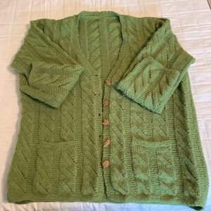 Vintage hand knitted green cardigan sweater with fall type buttons.